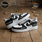 Black and white leather sneakers with custom text Kami Kehoe World Tour, three star graphics, and white laces on wood.!