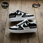 Custom black and white sneakers featuring Kami Kehoe world tour text, star icons, and white laces on wood surface.!