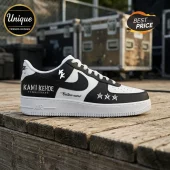 Custom black and white leather sneaker with Kami Kehoe World Tour text, star graphics, and white laces on wood planks.!