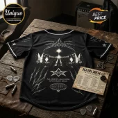Black baseball jersey with white gothic print, concert stage graphic, pentagrams, and tour date text on wooden table.!