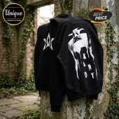 Black cotton hooded sweatshirt featuring a white star logo on the chest and a surreal KANDY face graphic on the back.!
