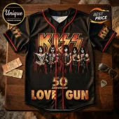 KISS band Love Gun 50th anniversary black baseball jersey with red piping and gold band graphics on a wooden table.!