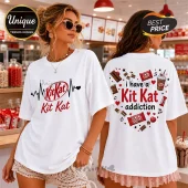 White oversized t-shirt featuring front KitKat heartbeat logo and back design with chocolate bars, hearts, and text.!