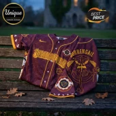 Maroon baseball jersey featuring gold dragon scale patterns, Ironpigs text, and a back dragon graphic on a wooden bench.!