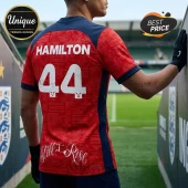 Red soccer-style jersey with navy sleeves featuring HAMILTON and number 44 in white, with Still I Rise text on the back.!