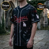 Black Los Angeles Dodgers baseball jersey with red lettering, white piping, and gothic skull and bird graphic prints.!