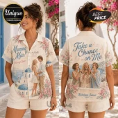 Woman wearing a beige button-down shirt printed with Mamma Mia movie scenes, Greek architecture, and floral patterns.!