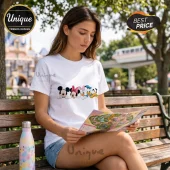 Mickey Mouse and Friends White Cotton T-Shirt featuring Mickey, Minnie, Daisy, Donald, and Pluto icons on park bench.