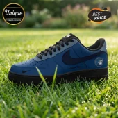 Custom blue and black leather sneaker with Minnesota Lynx team logo on heel, sitting on green grass background.!