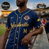 Navy blue baseball jersey with gold Nashville lettering, scale patterns, and small dragon silhouettes on sleeves.!