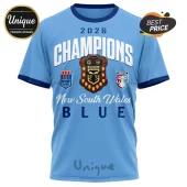 Light blue NSW Blues 2026 rugby t-shirt featuring Champions text, State of Origin shield, and team logos on the front.!