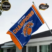 New York Knicks 2026 NBA Champions flag in blue and orange hanging from a metal pole against a white house.!