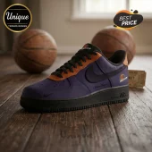 Purple and orange Phoenix Mercury basketball sneaker on wooden floor with two basketballs in the background.!