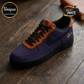 Custom purple and orange Nike Air Force 1 sneaker with black laces and Phoenix Mercury basketball logo on wood floor.!