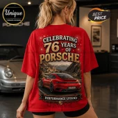 Red cotton t-shirt featuring a 76 years of Porsche graphic, a red sports car on a winding road, and gold text.!
