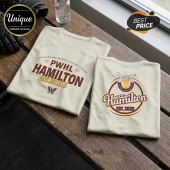 PWHL Hamilton Est 2026 Off-White T-Shirt featuring maroon and gold graphic team logos on soft cream cotton fabric.