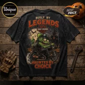 Rat Fink Harley-Davidson Haunt Hard T-Shirt featuring a green rodent character riding a motorcycle in a haunted cemetery.