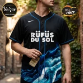 Black baseball jersey with white Rufüs Du Sol text, blue piping, and a swirling blue water graphic on the lower front.!