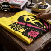 Yellow cotton t-shirt featuring a black Ghostface mask, pink lightning, and text reading One Call Changes Everything.!