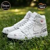 Simple Plan Signature Edition White Air Jordan 1 Sneakers featuring black band signatures on white leather in grass.