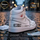 Simple Plan Signature Edition White Air Jordan 1 Sneakers featuring black piping, band logos, and custom autograph art.