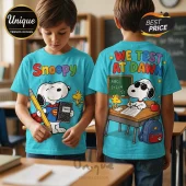 Cyan t-shirt featuring Snoopy with a pencil and notebook on the front and school scene on the back with We Test At Dawn text.!