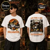 Snoopy x Jurassic Park Life Finds A Way T-Shirt featuring Snoopy in a safari hat and Halloween pumpkins on white cotton.