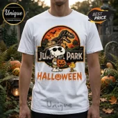 Snoopy x Jurassic Park Life Finds A Way T-Shirt featuring Snoopy in a ranger hat and sunglasses holding a pumpkin.