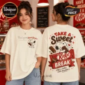Woman wearing an off-white cotton t-shirt with Snoopy graphic, KitKat logo, and text reading Take a Sweet Break.!