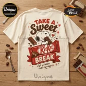 Cream colored crewneck t-shirt featuring Snoopy eating a KitKat bar graphic with red and brown vintage lettering.!