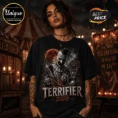 Black cotton t-shirt featuring Art the Clown with a blood moon and carnival theme, displaying Terrifier 2026 text graphics.!