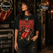 The Rolling Stones Vintage Tour I May Be Old T-Shirt on a woman featuring red tongue logo, black guitar, and record art.