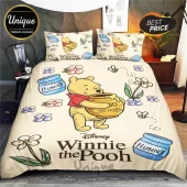 Winnie the Pooh bedding set with cream background, floral print, honey pots, and Disney character graphics on comforter.!
