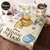 Winnie the Pooh bedding set featuring cream fabric, honey pots labeled Hunny, and Disney 100 Years logo graphics.!