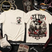 ZZ Top Texas Blues Kitty Road Trip Cream T-Shirt with graphic of a cat wearing sunglasses, hat, and playing a guitar.
