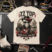 ZZ Top Texas Blues Kitty Road Trip Cream T-Shirt featuring a bearded cat in a leather jacket and hat playing guitar.