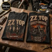 Two black cotton t-shirts featuring ZZ Top, Harley-Davidson graphics, desert landscapes, guitars, and flames on wood table.!