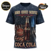 Coca Cola 9/11 Memorial Tribute T-Shirt featuring a vintage soda bottle, American flag backdrop, and twin light beams.
