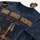Coca Cola 9/11 Memorial Tribute T-Shirt in navy blue featuring an American flag background and commemorative typography.