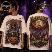 Foo Fighters Midnight Riot Halloween Rock Band T-Shirt featuring a jack-o-lantern, guitar, and graveyard graphics on white.