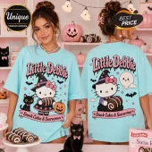 Little Debbie Hello Kitty Halloween Blue T-Shirt featuring a witch Hello Kitty, black cat, and pumpkins on light blue fabric.