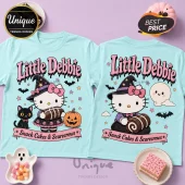 Little Debbie Hello Kitty Halloween Blue T-Shirt featuring a witch Hello Kitty, a black cat, a ghost, and snack cakes.