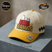 Peanuts Snoopy Cream Yellow Baseball Cap featuring Snoopy on his red doghouse with embroidered lettering on a textured brim.