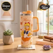 Sailor Venus Mary Name 40oz Handle Tumbler featuring yellow anime graphics, name text, and straw on a wooden desk.