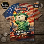 Snoopy 250 Years of America Independence T-Shirt featuring Snoopy as Statue of Liberty against a US flag background.